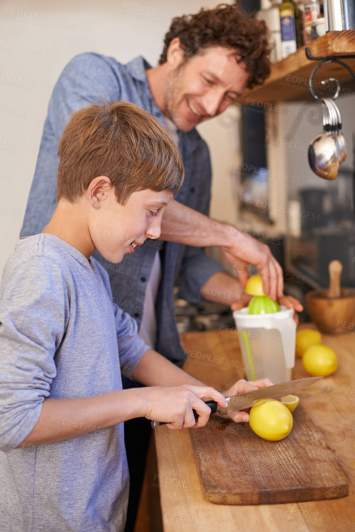 Buy stock photo Father, child and fruit for lemonade in home for nutrition on kitchen counter for breakfast, beverage or diet. Male person, son and juicer tool in apartment or fresh citrus, vitamin c or gut health