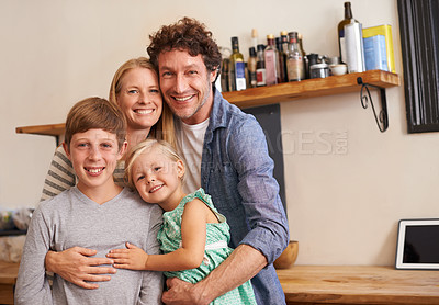 Buy stock photo A cropped portrait of a happy family standing in their kitchen at home