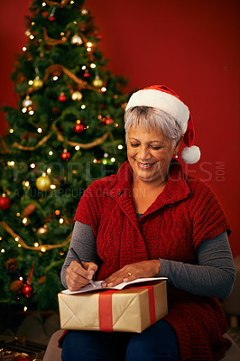 Buy stock photo Cropped shot of a mature woman writing a note at christmas