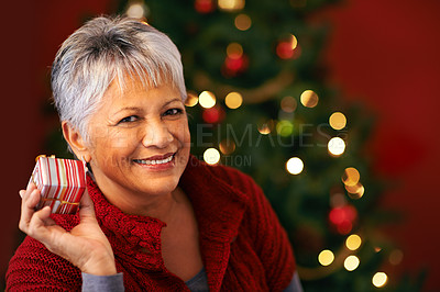 Buy stock photo Portrait, Christmas and present for mature woman, smile and box for celebration. Tree, decoration and gift for Christian holiday, happy or package for special family event for senior female at home