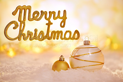 Buy stock photo Shot of golden Christmas decorations with a "merry christmas" message