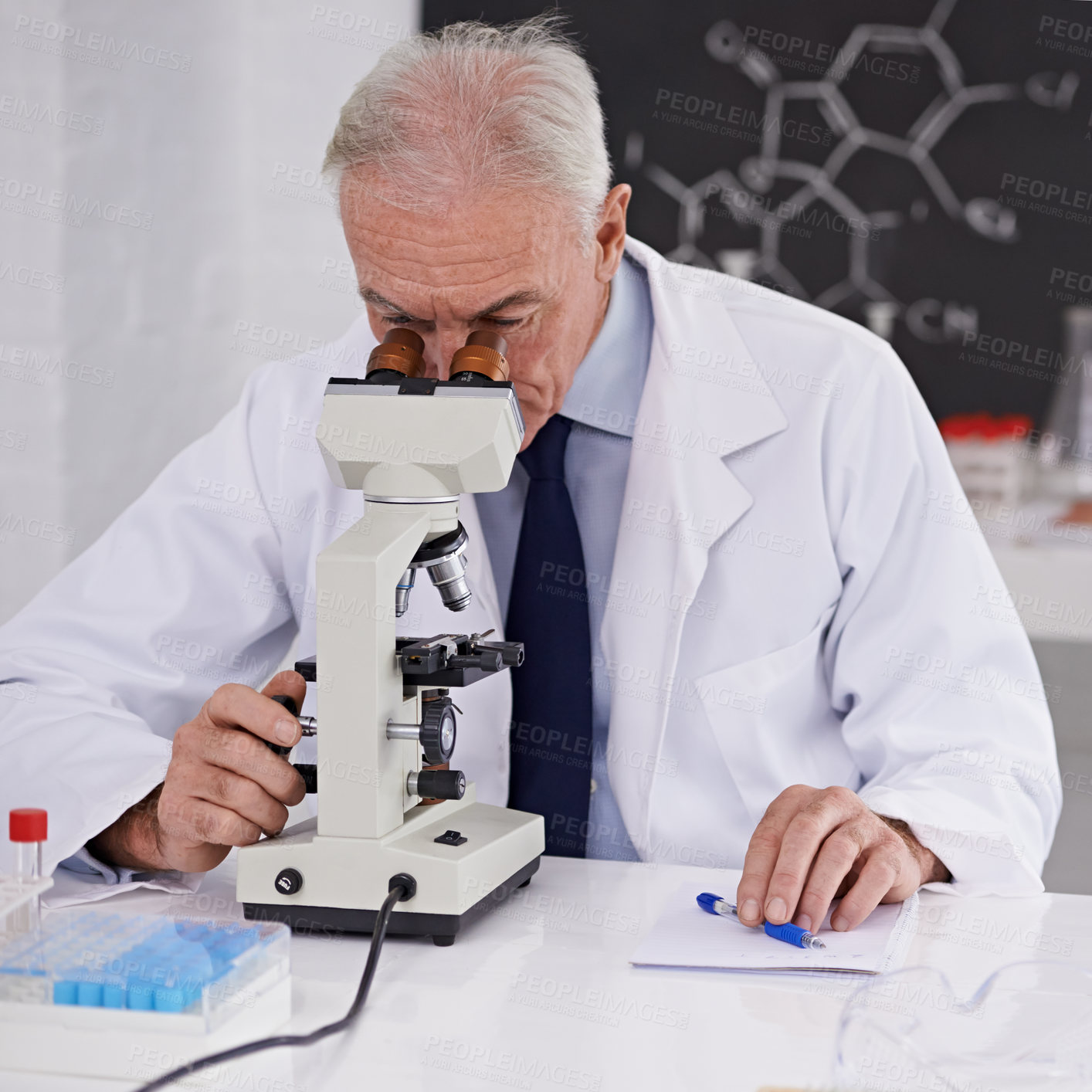 Buy stock photo Shot of a mature scientist using a microscope