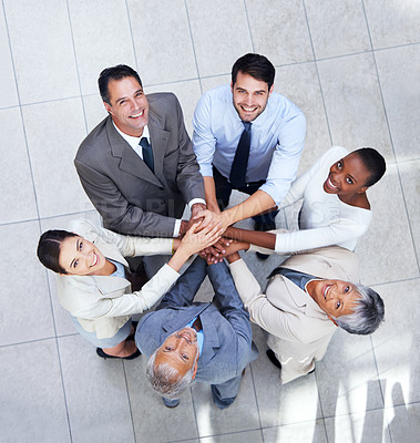 Buy stock photo Shot of a group of coworkers with their hands in a huddle