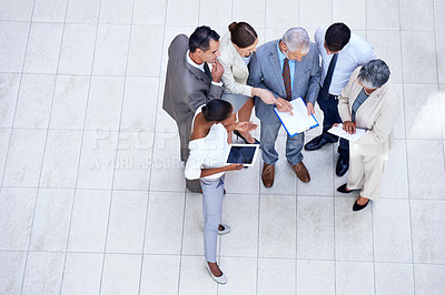 Buy stock photo Paperwork, tablet and business people in meeting in lobby of office in collaboration. Documents, digital technology and high angle of professional financial advisors in discussion for teamwork.