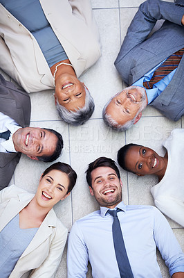 Buy stock photo Floor, circle and portrait of business people with smile for team building, collaboration and support. Professional employees, diversity and happy with trust, solidarity and partnership from above