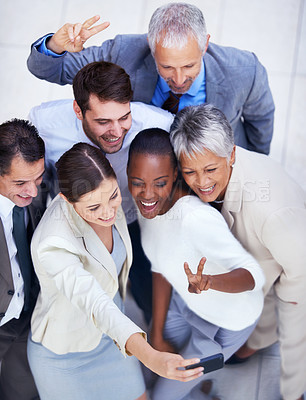Buy stock photo Shot of a diverse group of businesspeople taking a team photo of themselves