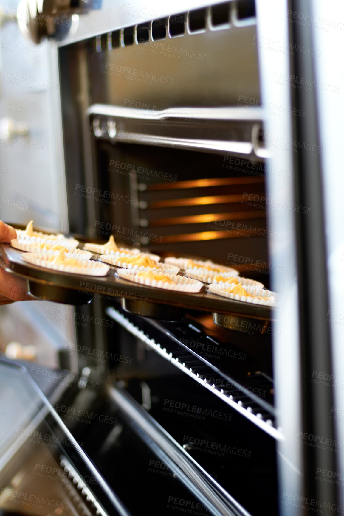 Buy stock photo Hands, closeup and tray in oven for cupcake, baking and food for small business, cafe or restaurant. Professional chef, baker or person with muffin in bakery, coffee shop or food industry startup