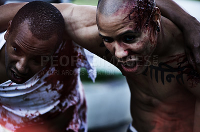 Buy stock photo A cropped shot of a man carrying an injured man to safety