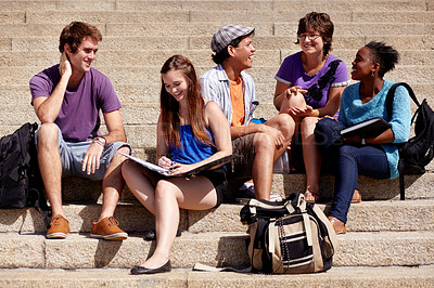 Buy stock photo Shot of a college students hanging out on campus