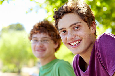 Buy stock photo Portrait of two boys sitting in a park on a sunny day