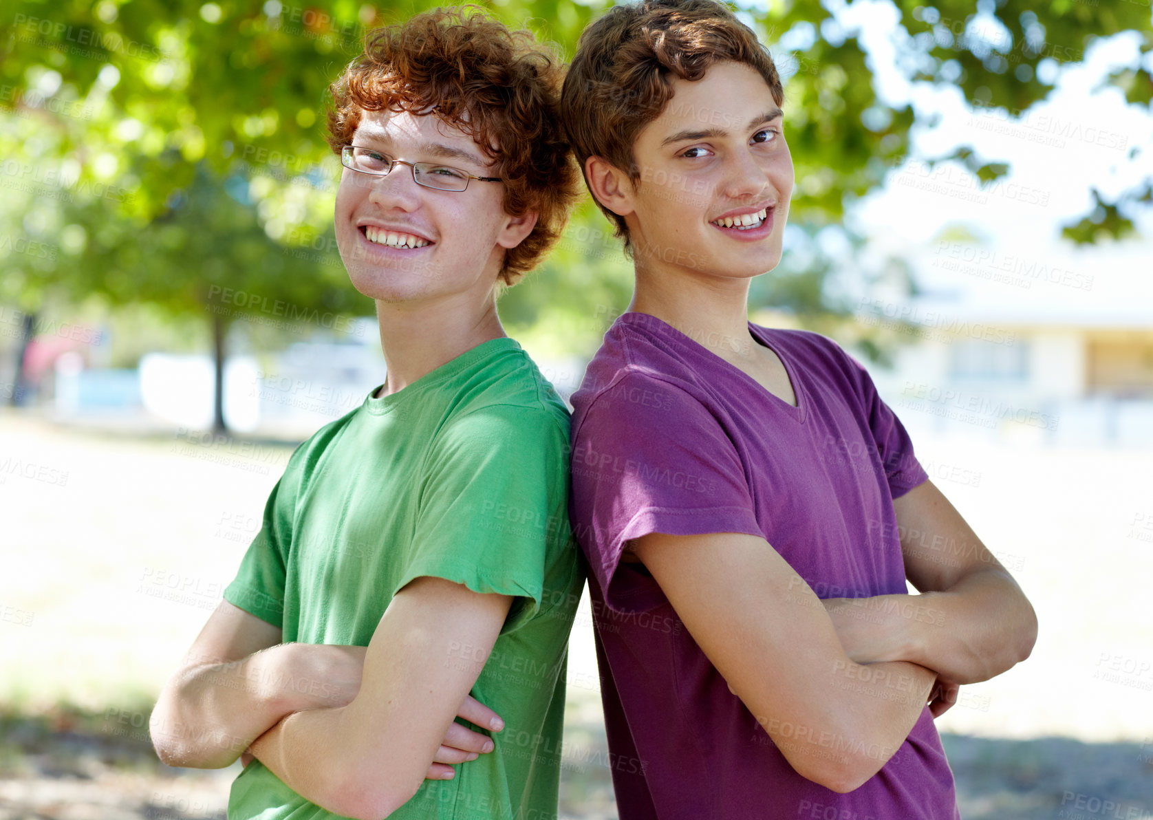 Buy stock photo Portrait of two boys standing back to back outdoors on a sunny day