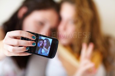 Buy stock photo Shot of two teenage sisters hanging out