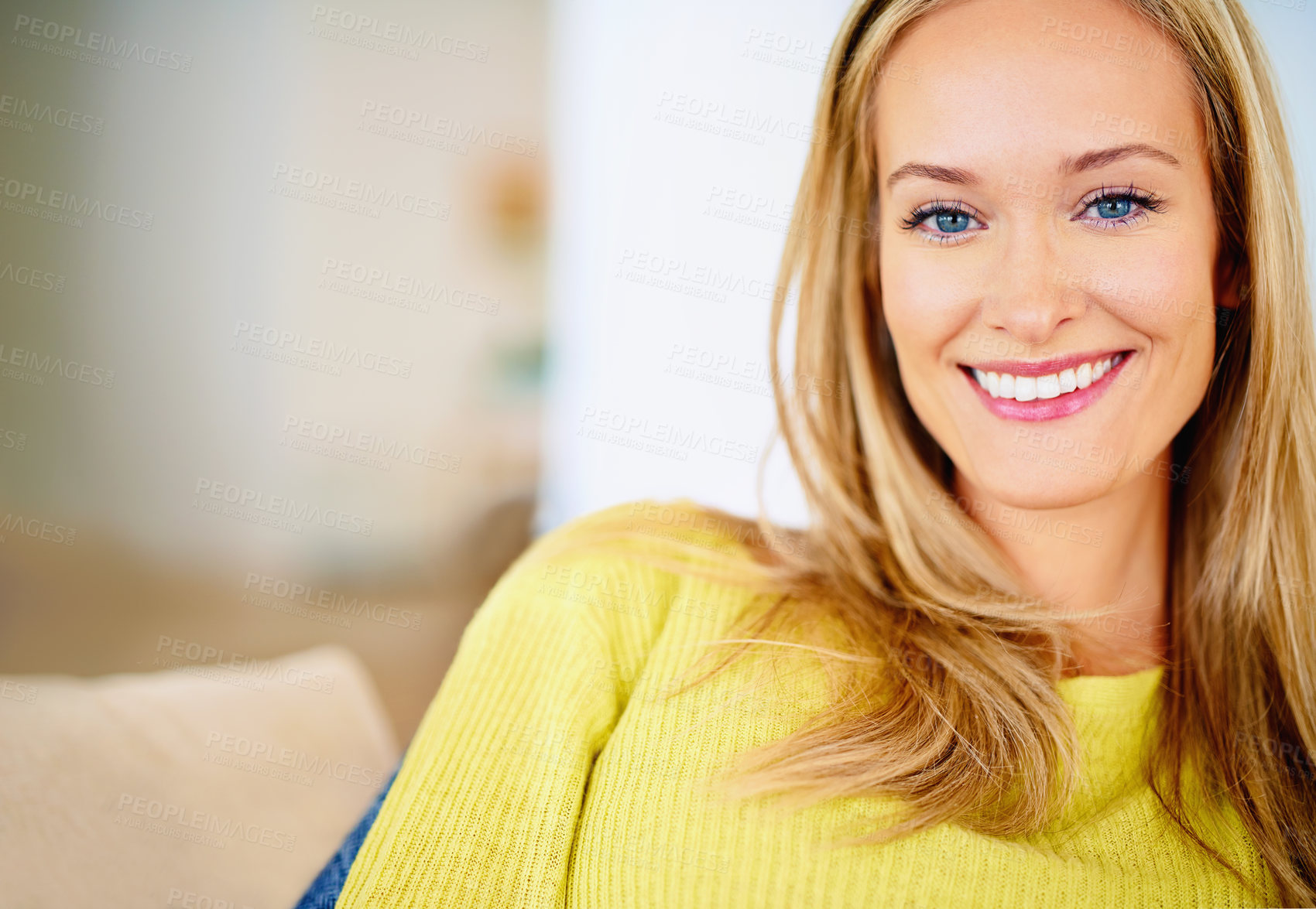 Buy stock photo Cropped shot of an attractive young woman relaxing on her sofa