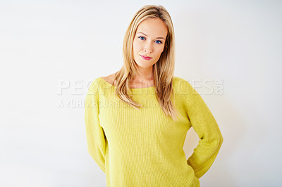 Buy stock photo Portrait of a beautiful young woman standing with her arms behind her back