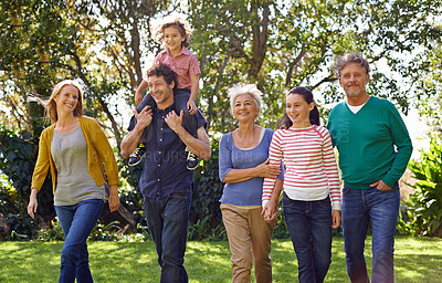 Buy stock photo Shot of a happy multi-generational family walking together outside