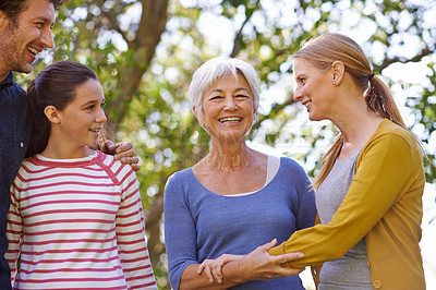 Buy stock photo Shot of a family standing together outside in the garden