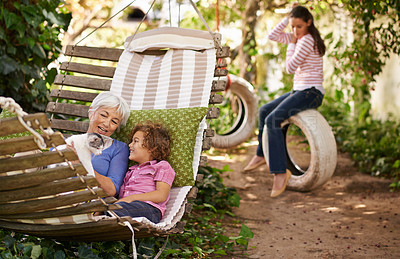 Buy stock photo Shot of a grandmother spending time with her grandchildren in the garden