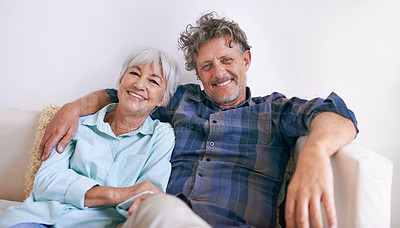 Buy stock photo Portrait of an affectionate senior couple sitting together in their home