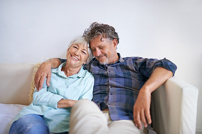 Buy stock photo Old couple, hug and relax on sofa with happiness at home, love and security with comfort for bonding. Marriage, partner and retirement together with smile, trust and loyalty with people in lounge