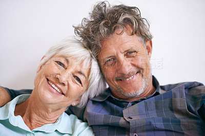 Buy stock photo Portrait of an affectionate senior couple sitting together