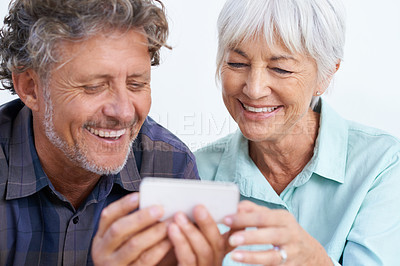 Buy stock photo Happy, cellphone and mature couple networking internet, mobile app or website together for bonding. Smile, love and senior man and woman reading online blog for information with phone for marriage.