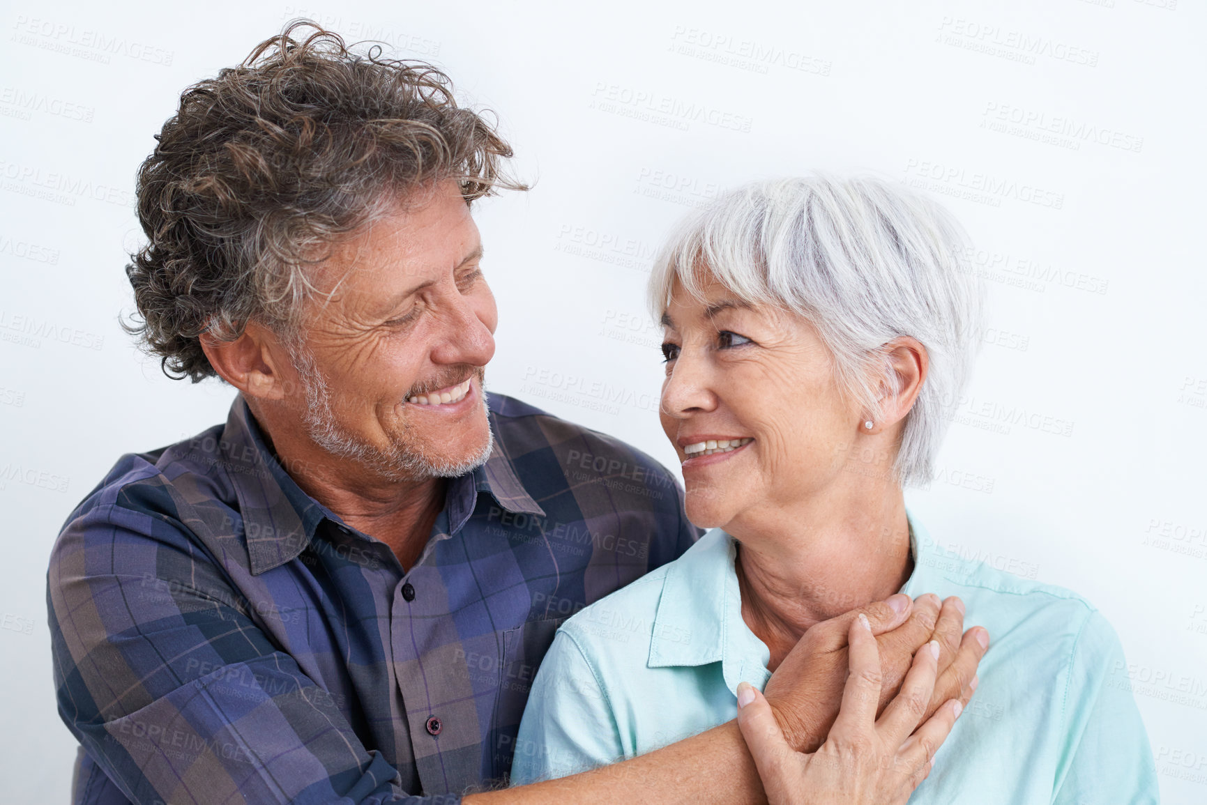 Buy stock photo Old couple, smile with happiness and love in studio, hug and security with comfort for bonding. Marriage partner, retirement and connection with people for trust and loyalty on white background