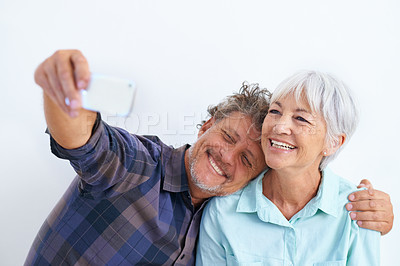 Buy stock photo Old couple, selfie and hug, happy together and social media post for memory and love on white background. Trust, support and loyalty with people in marriage, smile in picture for post and mobile app
