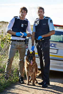Buy stock photo Full length portrait of two policemen and their dog