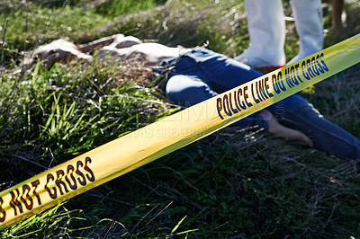 Buy stock photo Shot of a cordoned off crime scene containing the body of a woman