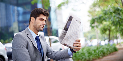 Buy stock photo Professional, businessman and reading newspaper in city for information, daily news and updates on local events. Outdoors, male person and serious with article for stories, journalism and newsletter