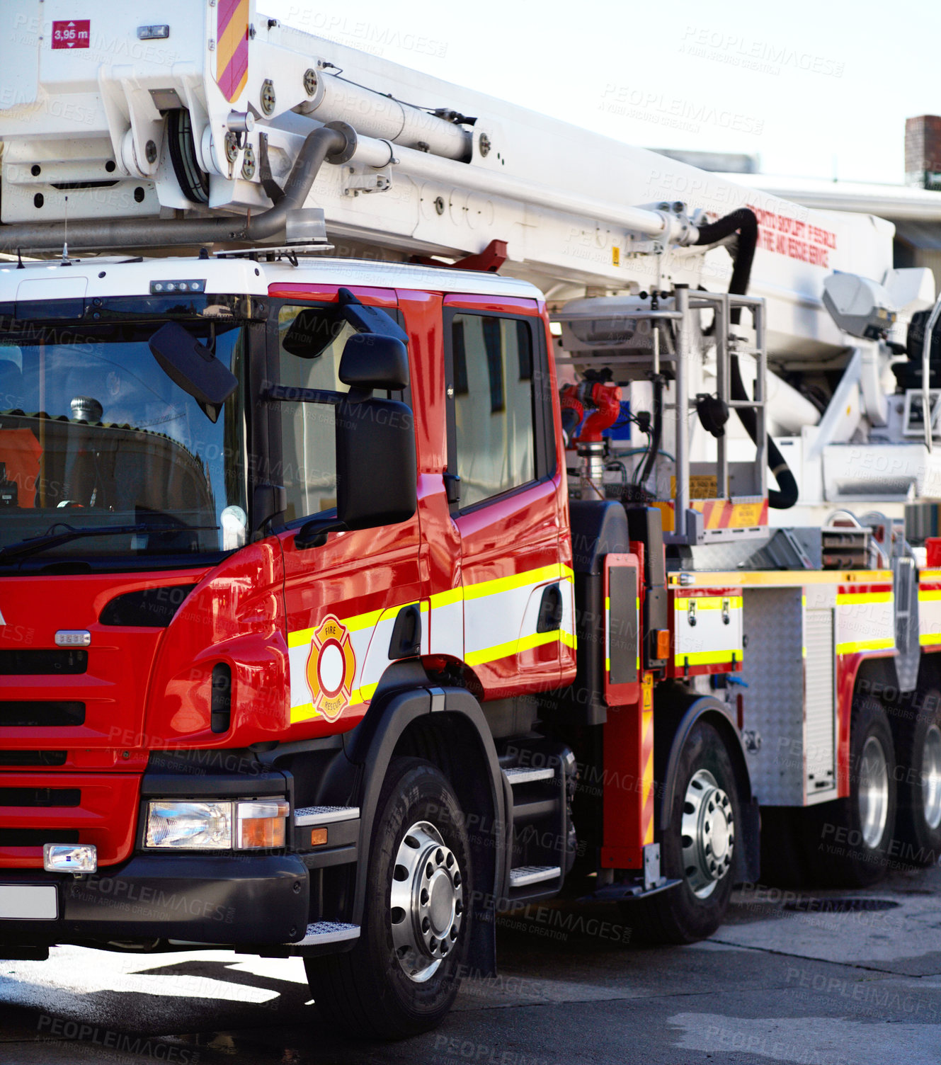 Buy stock photo Shot of a fire engine parked outside a fire station