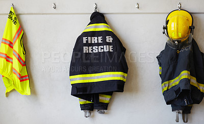 Buy stock photo Fireman, uniform and clothing hanging on wall rack at station for fire fighting protection. Firefighter gear, rescue jacket and helmet with reflector for emergency services, equipment or department