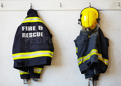 Buy stock photo Firefighter, uniform and clothing hanging on wall rack at station for fire fighting protection. Fireman gear, rescue jacket and helmet with reflector for emergency services, equipment or department