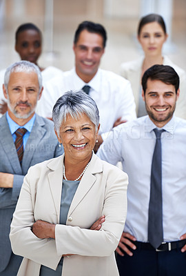 Buy stock photo Portrait of a smiling businesswoman surrounded by a group of her colleagues