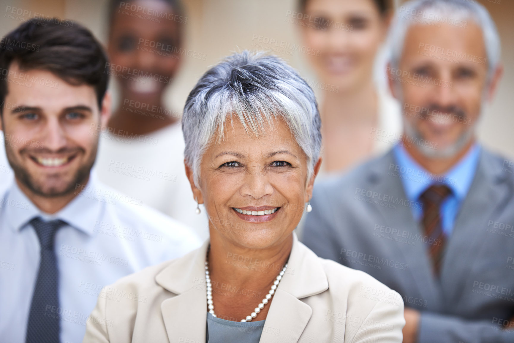 Buy stock photo Portrait of a smiling businesswoman surrounded by a group of her colleagues