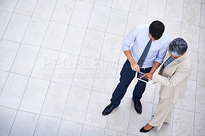 Buy stock photo High angle portrait of a professional man and woman using a tablet