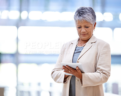 Buy stock photo Shot of a mature business woman holding a digital tablet