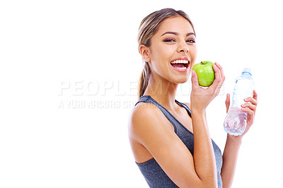 Buy stock photo Portrait of a sporty young woman holding an apple and a bottle of water against a white background