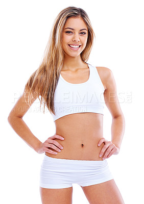 Buy stock photo Portrait of an attractive young woman in a sports bra standing against a white background