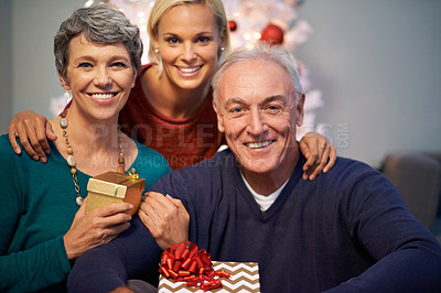 Buy stock photo Christmas, gift and senior family in portrait with love, happy and gratitude for holiday and tradition at night. Face of elderly mother, father and daughter with present for a celebration at home