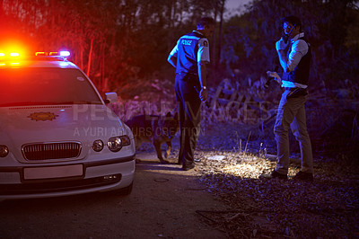 Buy stock photo Shot of two policemen calling for backup