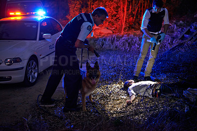 Buy stock photo Policemen arresting a wanted criminal outdoors