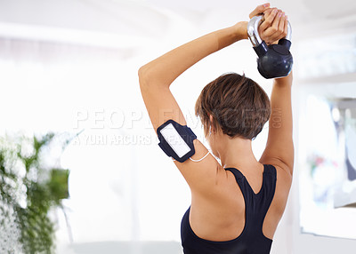 Buy stock photo Shot of a woman working out with a dumbbells