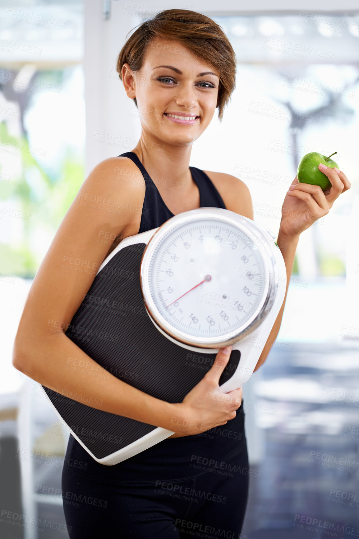 Buy stock photo Portrait, scale and happy woman eating apple for diet, nutrition or wellness with healthy body after exercise. Weight loss, smile and person with green fruit, vitamin c or organic food for fitness