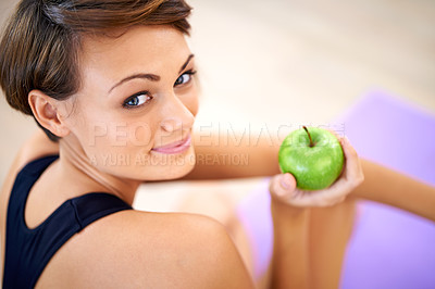 Buy stock photo Portrait, exercise and happy woman with apple in gym for diet, nutrition and wellness with healthy body. Face, fitness and person eating fruit for vitamin c or benefits of organic food on yoga mat