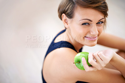 Buy stock photo Portrait, exercise and happy woman with apple in gym for diet, nutrition or wellness with healthy body. Face, fitness and person eating fruit for vitamin c or benefits of organic food on mockup space