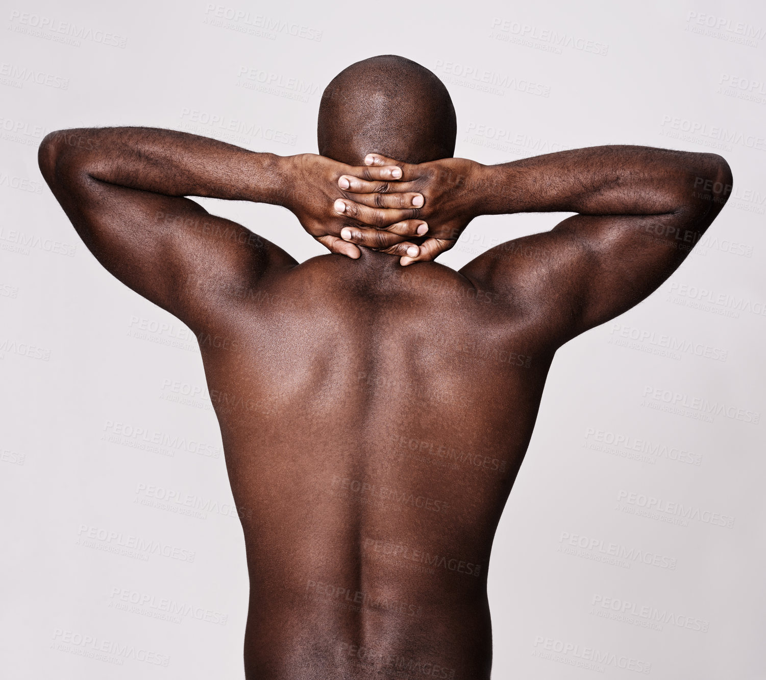 Buy stock photo Rearview shot of a muscular african american man holding his hands behind his neck