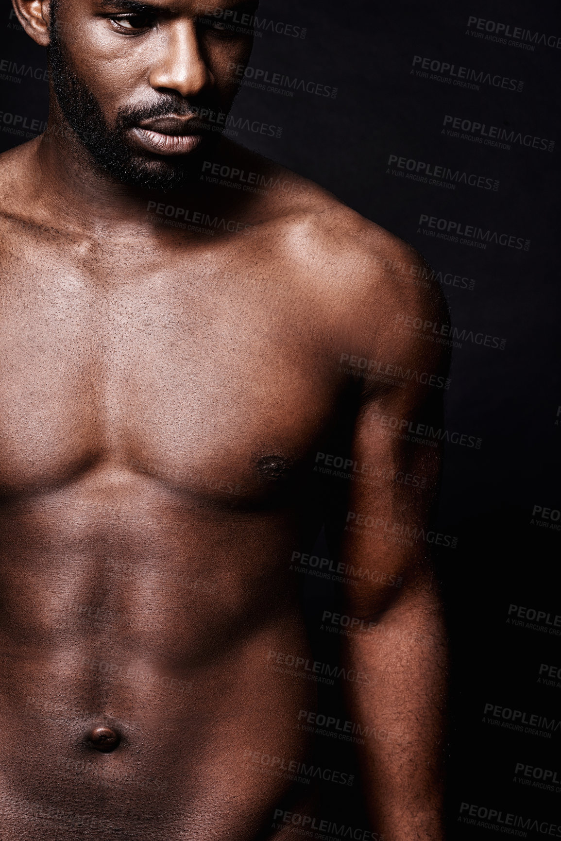 Buy stock photo Black man, stomach and beauty on a dark background for dermatology and shadow or light with art deco or aesthetic. Cosmetics model or young person thinking in studio with shirtless abs and fitness 