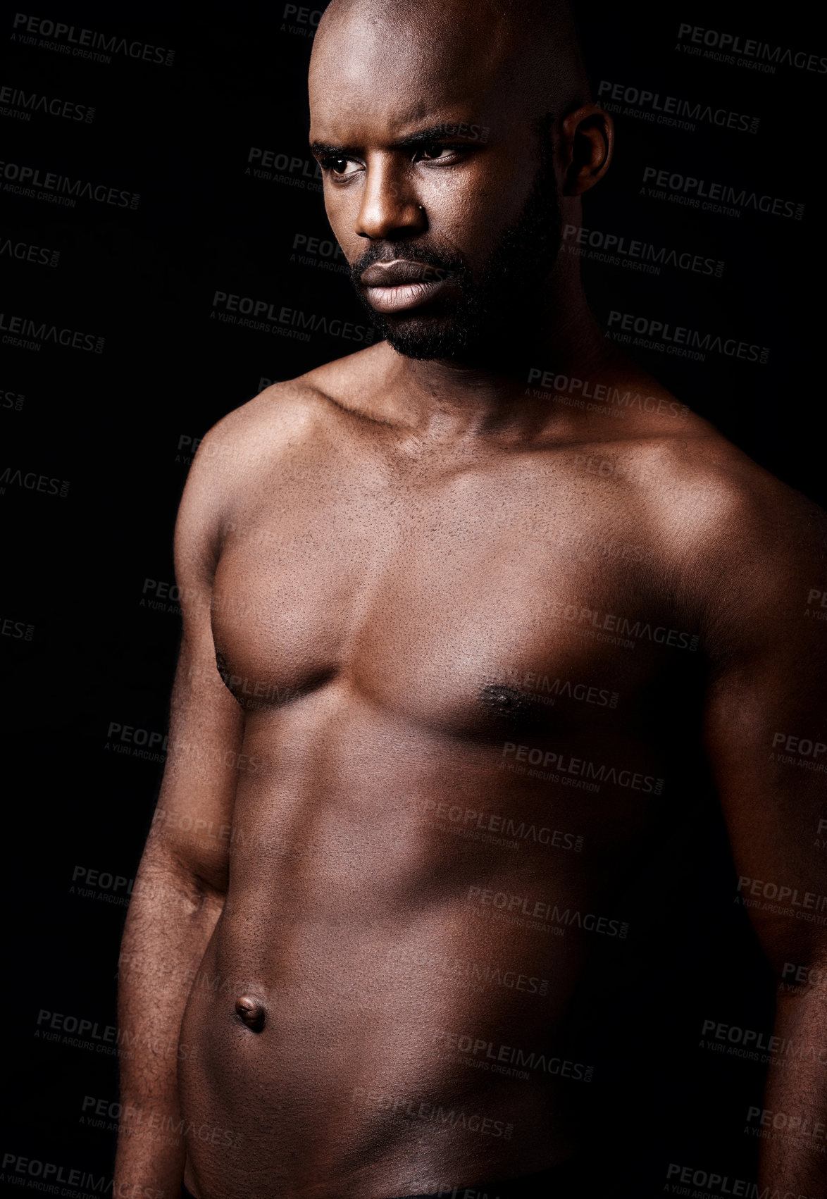 Buy stock photo Studio shot of a muscular man looking serious