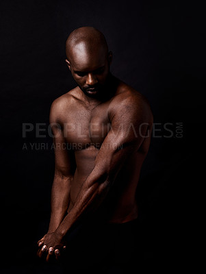 Buy stock photo Black man, muscle and beauty on a dark background for dermatology and shadow or light with art deco or aesthetic. Bodybuilder, model or strong person in studio with arms, workout and fitness results